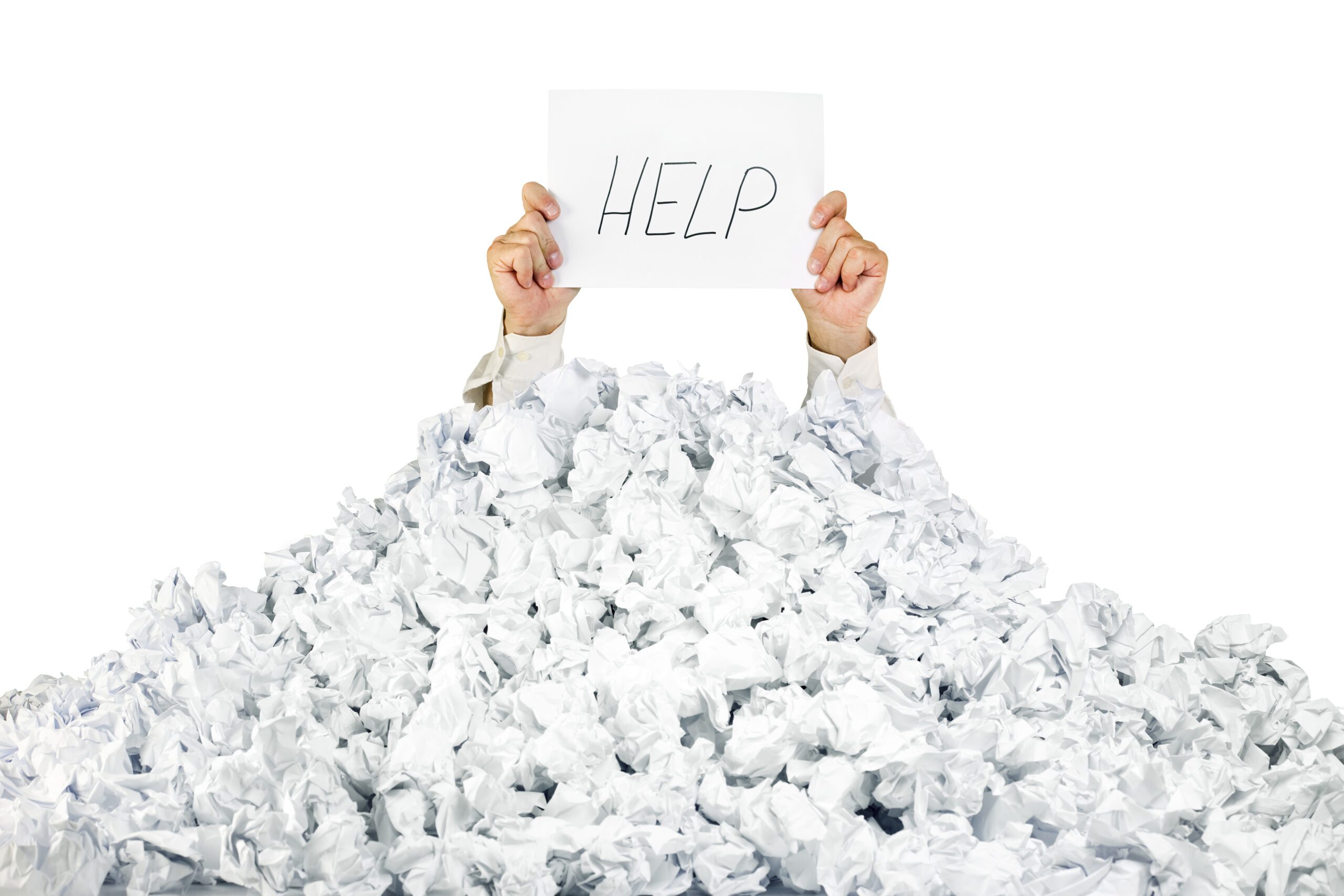 Person buried in paper holding "Help" sign.
